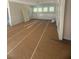 Bright living room featuring wainscoting, large windows, and unfinished flooring at 70 Valebrook Ct, Youngsville, NC 27596