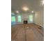 Cozy living room with a fireplace and large windows providing natural light and serene views of the outdoors at 70 Valebrook Ct, Youngsville, NC 27596
