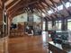 Inviting interior featuring a grand stone fireplace, wood beams, and elegant furnishings at 70 Valebrook Ct, Youngsville, NC 27596