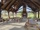 Open pavilion with a stone fireplace and ample seating, ideal for outdoor gatherings at 70 Valebrook Ct, Youngsville, NC 27596