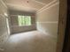 Unfinished room with drywall, windows, and sliding door access to the outside at 70 Valebrook Ct, Youngsville, NC 27596