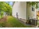 Side view of the home, showcasing the siding, fenced yard, and the HVAC unit at 708 Brye St, Durham, NC 27703
