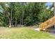 Backyard view showcasing stairs, trees, and grass at 708 Brye St, Durham, NC 27703