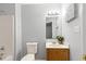 Bathroom featuring a single sink vanity, mirror and lighting fixtures with a gray paint scheme at 708 Brye St, Durham, NC 27703