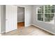 Bedroom featuring wood floors, light gray walls, and a door at 708 Brye St, Durham, NC 27703
