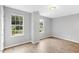 Bright bedroom showcasing wood-look floors, neutral paint, and double windows offering natural light at 708 Brye St, Durham, NC 27703