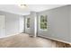 Bedroom featuring wood-look floors, neutral paint, and large windows offering natural light at 708 Brye St, Durham, NC 27703