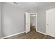 Bedroom featuring wood floors, light gray walls, and two doors at 708 Brye St, Durham, NC 27703