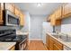 Kitchen featuring stainless steel appliances, wood cabinets, and wood floors at 708 Brye St, Durham, NC 27703