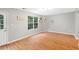 Bright and airy living room featuring hardwood floors and a large window at 708 Brye St, Durham, NC 27703
