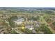 Aerial view of the neighborhood nestled among lush trees with golf course and tennis courts nearby at 76501 Rice, Chapel Hill, NC 27517