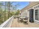 Outdoor deck featuring dining and lounge seating, offering a tranquil view of the surrounding trees at 76501 Rice, Chapel Hill, NC 27517