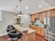 Modern basement bar area with granite counters, stainless steel appliances, and pendant lighting at 76501 Rice, Chapel Hill, NC 27517