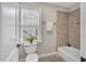 Cozy bathroom showcases a tiled shower, soaking tub, and sunlit window at 76501 Rice, Chapel Hill, NC 27517