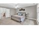 Spacious bedroom features neutral tones, ceiling fan, and sunny windows, creating a serene retreat at 76501 Rice, Chapel Hill, NC 27517