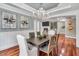 Elegant dining room featuring a chandelier, wainscoting, hardwood floors and view into the living room at 76501 Rice, Chapel Hill, NC 27517