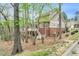 Charming two-story brick home featuring upper level deck, lush trees, and bright natural light at 76501 Rice, Chapel Hill, NC 27517
