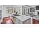 Kitchen with stainless steel gas cooktop, marble countertop island, and an open view of the outdoor landscape at 76501 Rice, Chapel Hill, NC 27517