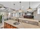 Basement kitchenette featuring granite counters, stainless steel sink, and views of theater and dining areas at 76501 Rice, Chapel Hill, NC 27517