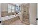 Luxurious main bathroom featuring a jetted tub and a frameless glass shower at 76501 Rice, Chapel Hill, NC 27517