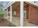 Covered patio with exposed rafters and brick exterior at 76501 Rice, Chapel Hill, NC 27517