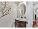 Elegant powder room featuring a marble countertop and decorative mirror at 76501 Rice, Chapel Hill, NC 27517