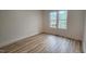 A bright bedroom is complemented by wood flooring and natural light at 795 Terry Rd, Hurdle Mills, NC 27541
