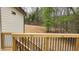 Spacious wood deck with black metal railing overlooking trees and graded lot at 795 Terry Rd, Hurdle Mills, NC 27541