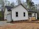 View showcases the home's charming exterior, highlighted by a convenient attached garage at 795 Terry Rd, Hurdle Mills, NC 27541