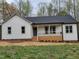 Charming exterior of a newly built home with a welcoming front porch and fresh landscaping at 795 Terry Rd, Hurdle Mills, NC 27541