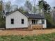 Beautifully crafted single story home boasts white siding, dark roof, and inviting front porch at 795 Terry Rd, Hurdle Mills, NC 27541