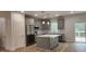 Modern kitchen boasts an island, stainless appliances, and plentiful natural light at 795 Terry Rd, Hurdle Mills, NC 27541