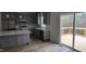 Modern kitchen features stainless appliances, gray cabinetry, and sliding doors to deck at 795 Terry Rd, Hurdle Mills, NC 27541