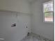 Laundry room with white walls, tiled flooring and a window providing natural light at 795 Terry Rd, Hurdle Mills, NC 27541