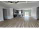 Expansive view of a modern living room open to the kitchen with light wood flooring at 795 Terry Rd, Hurdle Mills, NC 27541