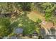 Aerial view of the backyard, showing deck, gazebo, firepit, and lush surroundings at 8008 Hollander Pl, Raleigh, NC 27606