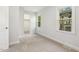 Light-filled bedroom with plush carpet, neutral paint, and a scenic window view, offering a cozy space at 8008 Hollander Pl, Raleigh, NC 27606