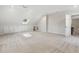Spacious bonus room with carpet, natural light from skylight, built in cabinets, and recessed lighting at 8008 Hollander Pl, Raleigh, NC 27606