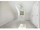 Well lit bonus room with neutral carpet, closet, window and skylight, and access to attic storage at 8008 Hollander Pl, Raleigh, NC 27606
