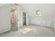 Bonus room with neutral carpet, closet, attic window, built-in cabinets, and an open doorway at 8008 Hollander Pl, Raleigh, NC 27606