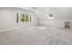 Large bonus room featuring carpeting, natural light, attic angles, and built-in storage and shelving at 8008 Hollander Pl, Raleigh, NC 27606