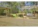 Large wooden deck with gazebo and swing set, perfect for enjoying the lush green backyard at 8008 Hollander Pl, Raleigh, NC 27606