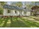 Charming single-story home with a well-manicured lawn and mature landscaping at 8008 Hollander Pl, Raleigh, NC 27606