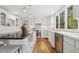 Well-lit kitchen with white cabinets, granite countertops, hardwood floors and stainless steel appliances at 8008 Hollander Pl, Raleigh, NC 27606