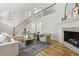 Open living room with a fireplace, tall ceilings, staircase, hardwood floors and natural light at 8008 Hollander Pl, Raleigh, NC 27606