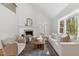 Spacious living room with fireplace, seating, natural light, hardwood floors and access to the outdoors at 8008 Hollander Pl, Raleigh, NC 27606