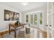 Bright office space with hardwood floors, a large desk, natural light, and French doors leading to the outside at 8008 Hollander Pl, Raleigh, NC 27606