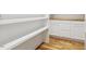 Well-organized pantry featuring white shelving, cabinetry, and beautiful hardwood floors, perfect for any home cook at 8008 Hollander Pl, Raleigh, NC 27606