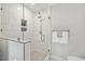 Stylish shower featuring white subway tile, glass enclosure, and sleek fixtures for a modern spa experience at 8008 Hollander Pl, Raleigh, NC 27606