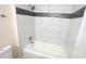 Renovated bathroom with white tile and updated shower at 909 Windcrest Rd, Durham, NC 27713